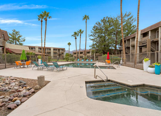Resort Style Pool and Sundeck with Palm Trees at Verde Apartments in Tucson, AZ.