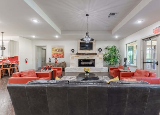 Community Clubroom with Large Seating Area with TV's and Chairs  at Legacy Brooks, San Antonio