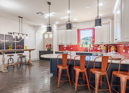 Clubroom Kitchen and Dining Room with Stools and Chairs  at Legacy Brooks, 78223