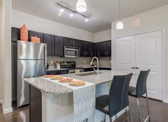 Kitchen Island with Stainless Steel Appliances and Cabinetry  at Legacy Brooks, San Antonio, 78223