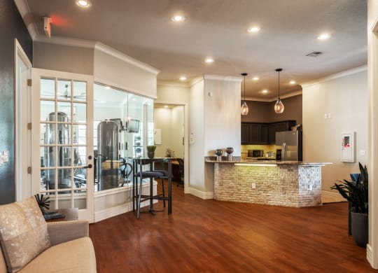 Kitchen and living room with hardwood floors at Park Hudson Place Apartments, Bryan, TX, 77802