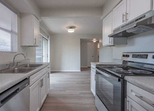 Kitchen with white cabinets and a stainless steel stove  at Riverstone, Bryan