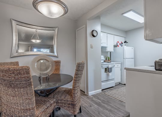 Dining area with a table and chairs and a kitchen in the background  at Riverstone, Bryan, TX