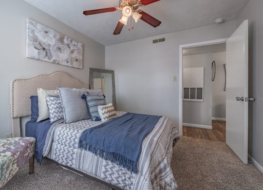 Bedroom with a bed and a ceiling fan  at Riverstone, Bryan, TX, 77802