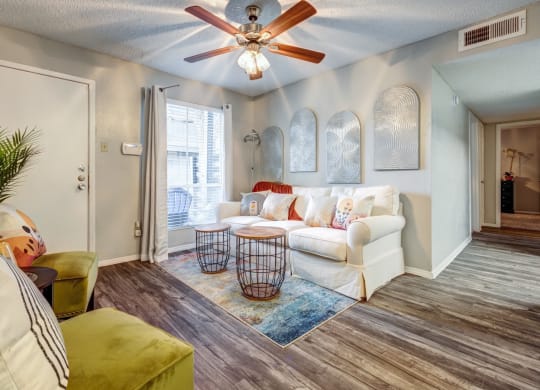 Living room with a white couch and a ceiling fan  at The Wick, Texas, 77840