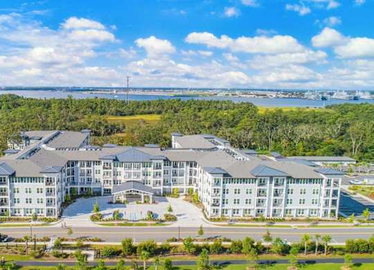 A large, modern building complex with multiple wings and a spacious courtyard in the center.