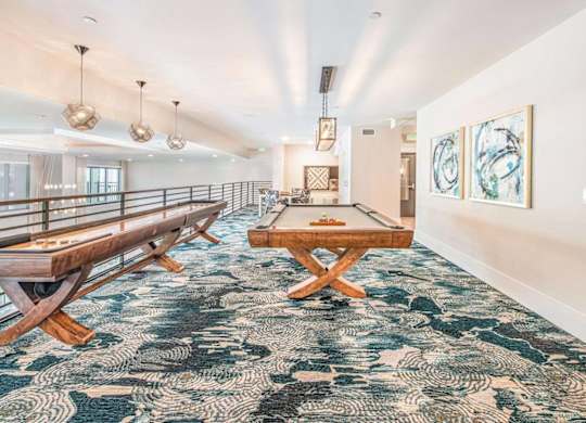 A room with a long wooden bench and a table with chairs.