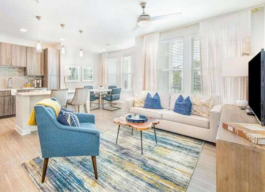 A modern kitchen with a blue chair and a coffee table.