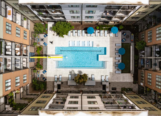 an aerial view of a swimming pool in the middle of a building