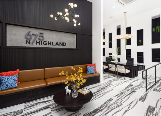 the lobby of 625 north highland with a couch and a table