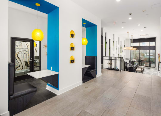 the lobby of a building with blue and white walls and yellow lights