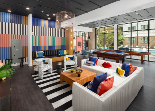 a lobby of a building with couches and a table