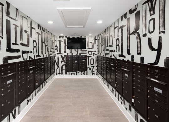 a hallway with lockers and a television in a room with graffiti on the wall
