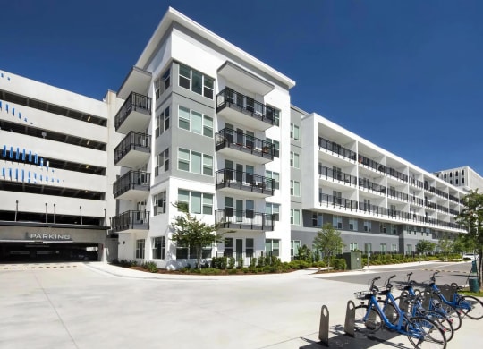 Anchor Riverwalk Community Building with Adjacent Parking Garage and Bike Share Station