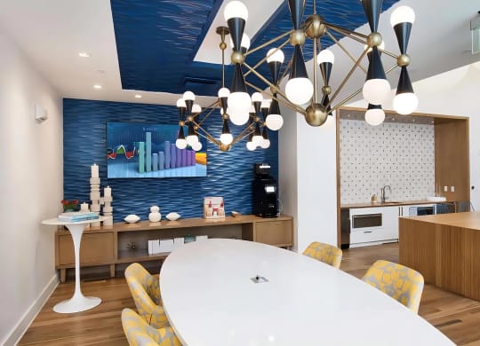 Community Lounge with TV, Coffee Station, and Modern Lighting Fixtures