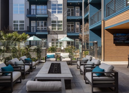 an outdoor patio with chairs and tables and buildings
