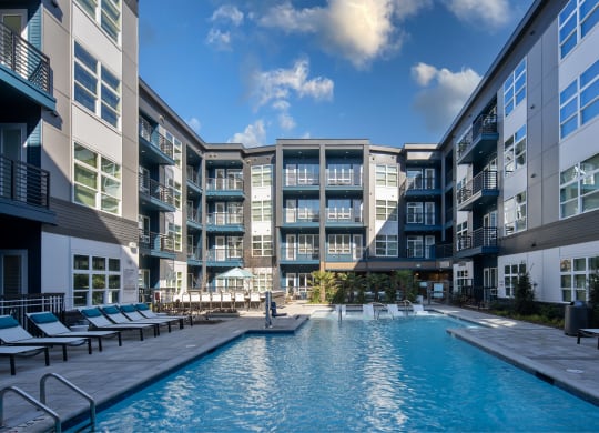 a swimming pool in front of an apartment building