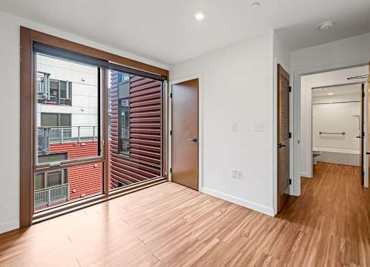 A room with a wooden floor and a white door.