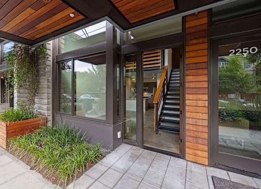 A modern building with a wooden facade and a glass door.