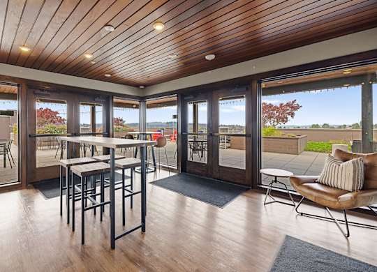 A wooden table with chairs is in a room with a wooden ceiling and floor.