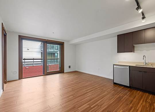 A kitchen area with a sink and a refrigerator.