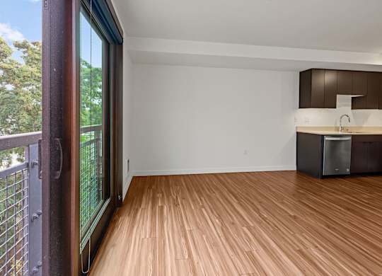 A room with wooden flooring and a white wall.