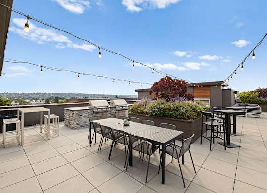 A patio with a table and chairs is set up on a rooftop.