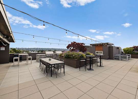 A patio with a table and chairs is set up on a rooftop.