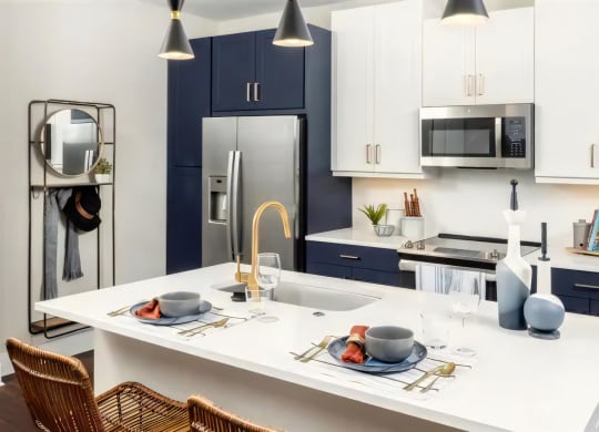 Broadstone Upper Westside Apartments Kitchen Island Kitchen with Breakfast Bar Ample Cabinet Space and Self Closing Drawers