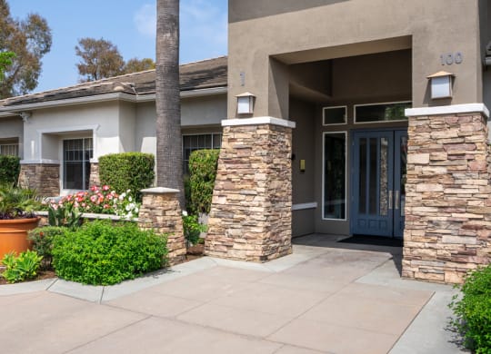 the front of a house with a walkway and a blue door