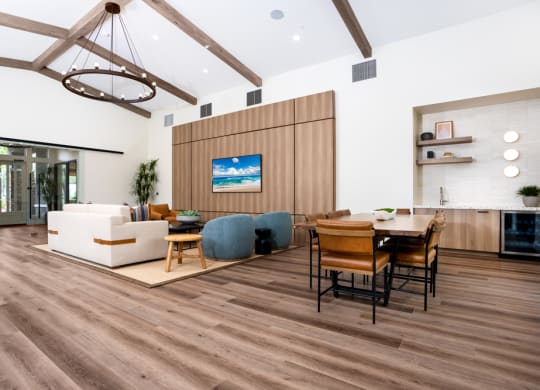 a living room and dining room with wooden floors and a table and chairs