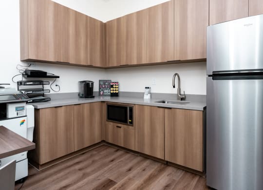 a kitchen with stainless steel appliances and wooden cabinets