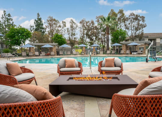 a swimming pool with chairs and a coffee table
