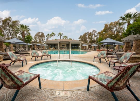 a swimming pool with chairs and umbrellas at the resort