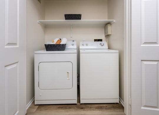 a washer and dryer in a small laundry room