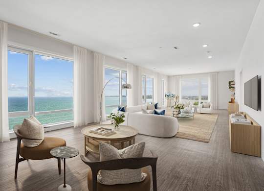 A modern living room with a view of the ocean.