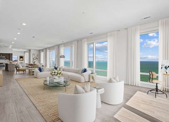 A modern living room with a view of the ocean.
