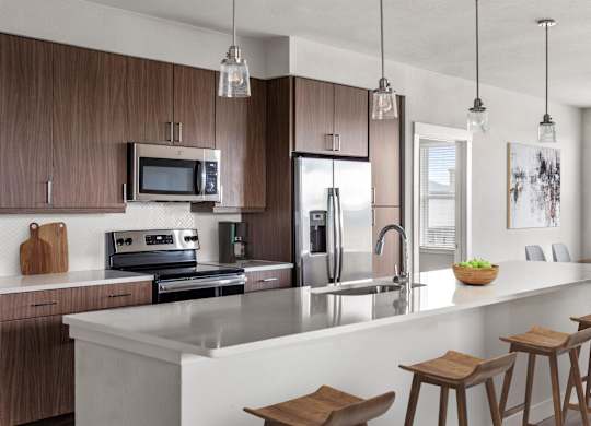 Gateway Arvada Ridge Gourmet Kitchen with Stainless Steel Appliances and Pendant Lighting