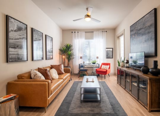 Contemporary Living Room with Wall Art, Ceiling Fan, and Desk Space