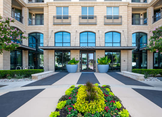 Domain at The Gate Entrance Framed by Flowers and Modern Architecture