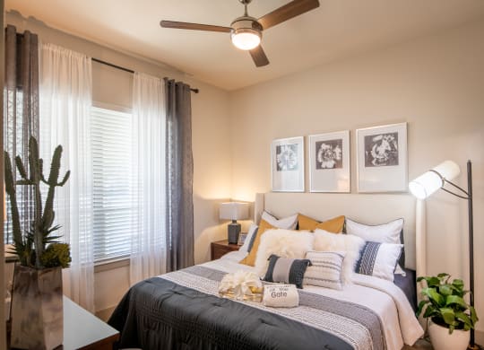 Cozy Bedroom Featuring Plush Bedding and Ceiling Fan