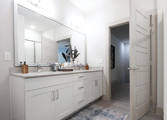 Modern Bathroom Featuring Double Vanity and Glass-Enclosed Shower