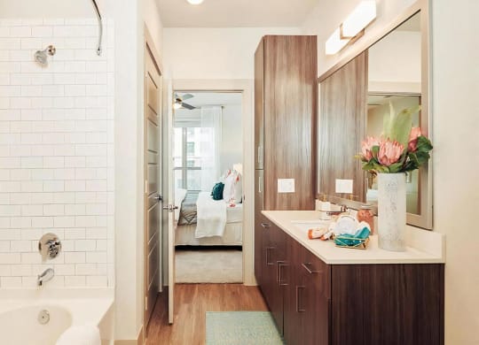 Ensuite Bathroom with Soaking Tub and Contemporary Wood Cabinets