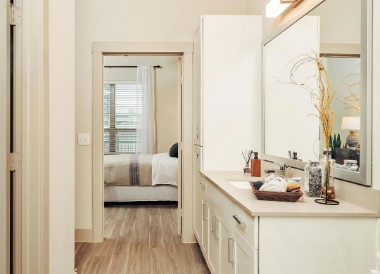 Spacious Ensuite Bathroom with Large Mirror and Modern Cabinetry
