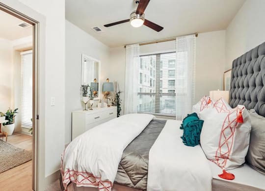 Spacious Bedroom Featuring Ceiling Fan and Natural Light