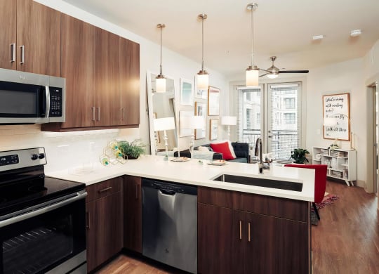 Open-Concept Layout with Kitchen, Living Area, and Access to Patio