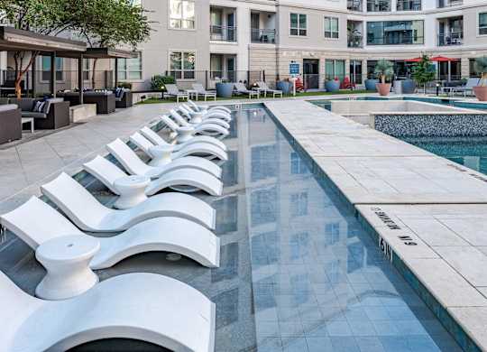 Stylish Poolside Sundeck Featuring Lounge Chairs and Community Seating