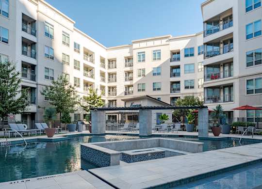 Resort-Style Pool with Water Features and Private Courtyard Seating