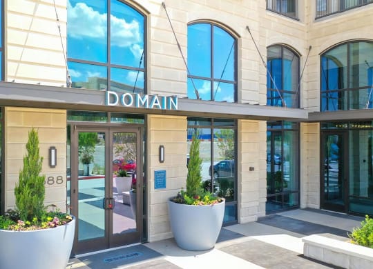 Leasing Office Entry at Domain at The Gate with Arched Windows and Modern Planters
