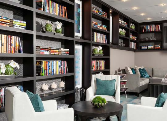 Lounge with Floor-to-Ceiling Library Shelves and Modern Seating